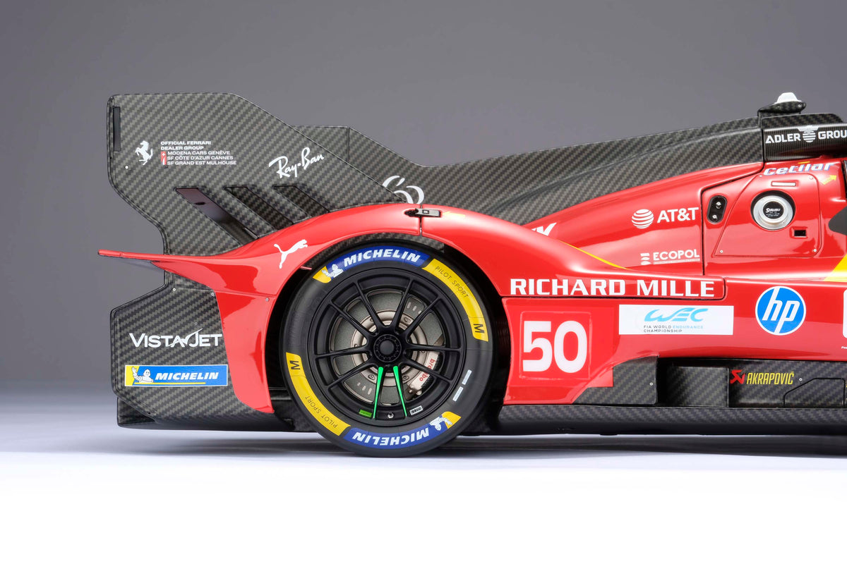 A red and yellow Ferrari 499P 2025 Le Mans racing car at 1.8 scale with multiple sponsors, displayed on a light background.