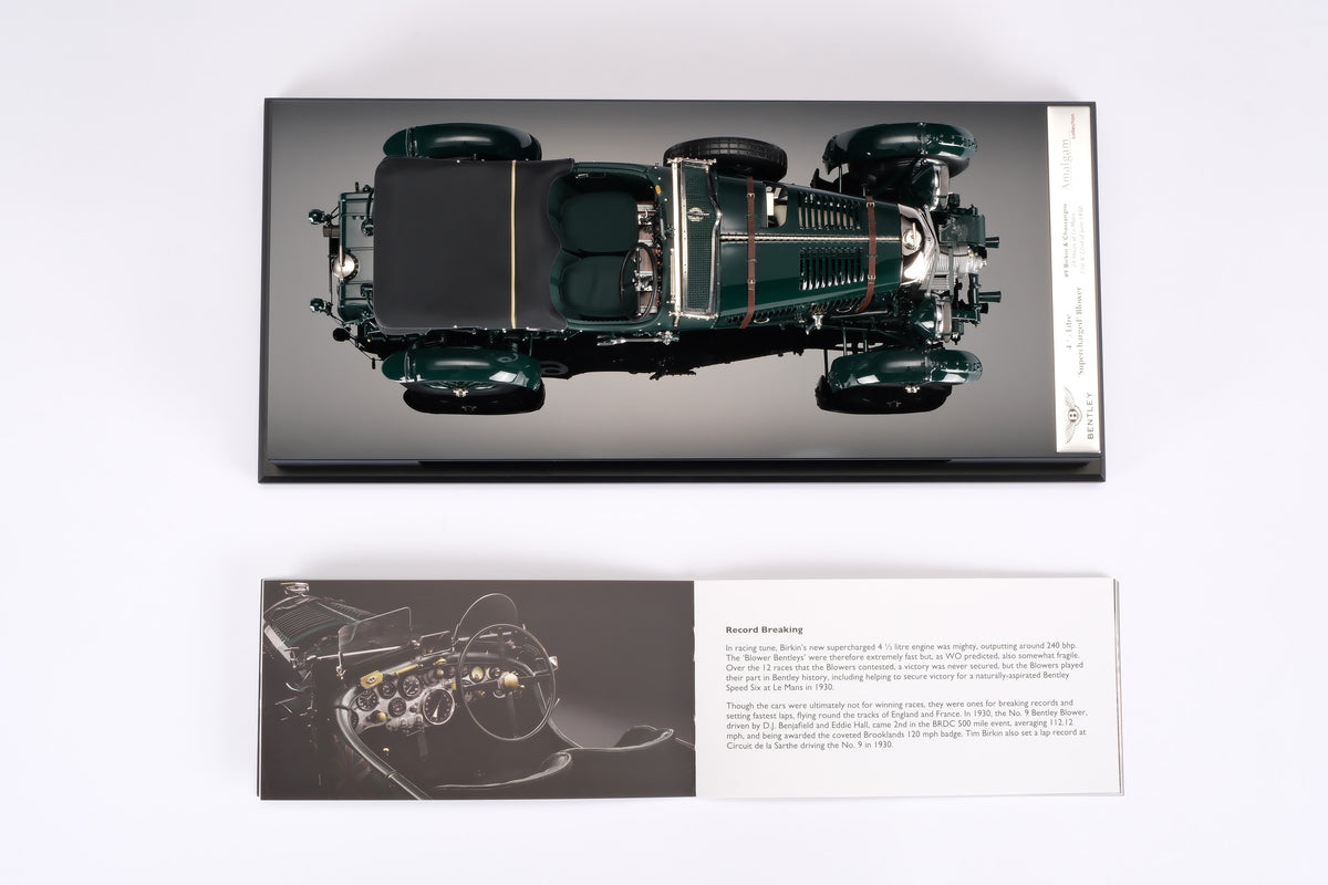 "1929 Bentley Blower" - 1930 Le Mans - Birkin & Chassagne - a dark green vintage 1:18 scale model on a base next to a certificate booklet positioned on a light background.