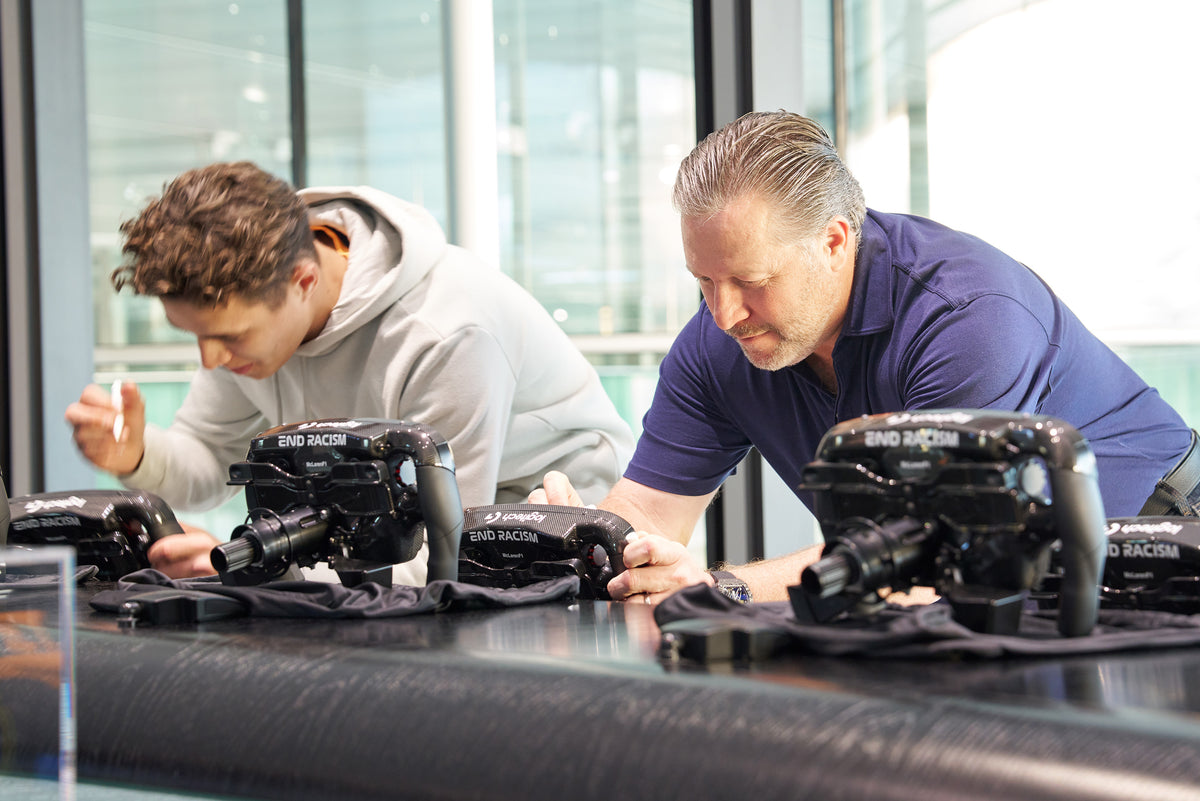 Lando Norris and Zak Brown, McLaren Racing. signing Amalgam Collection full size replicas of the McLaren MCL36 steering wheel 