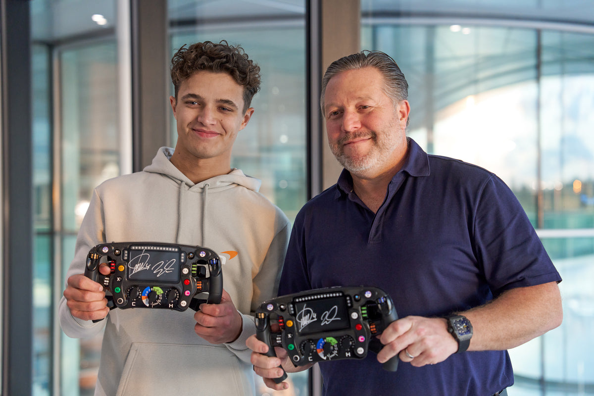 Lando Norris and Zak Brown, McLaren Racing. holding up signed Amalgam Collection full size replicas of the McLaren MCL36 steering wheel 
