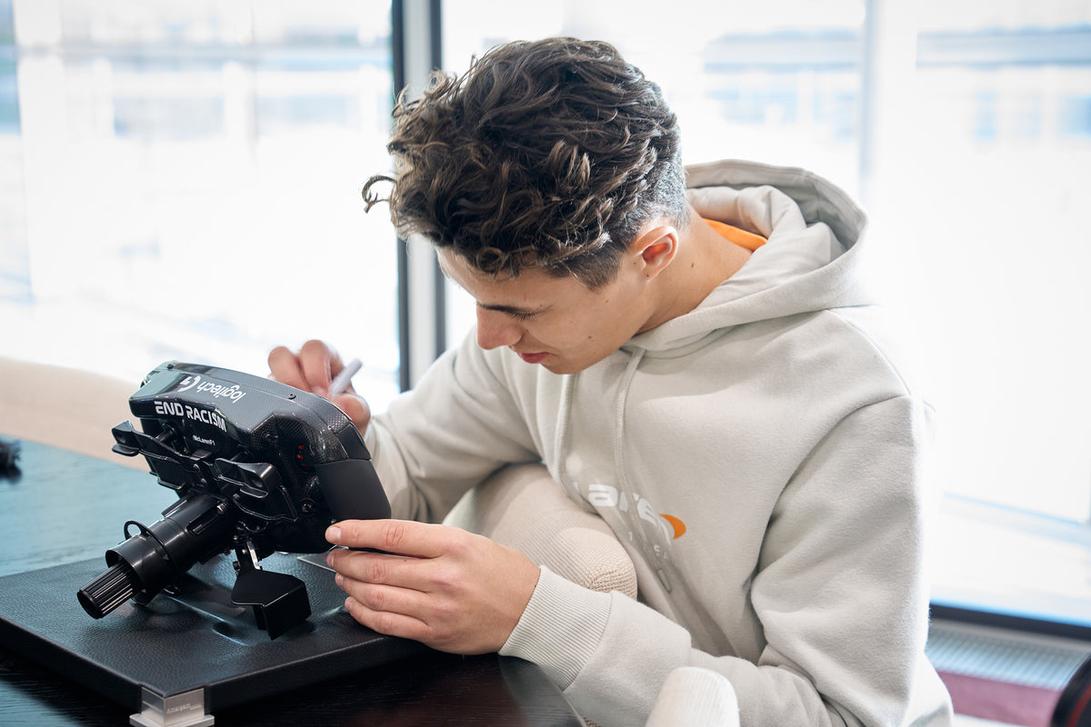 Lando Norris, McLaren Racing. signing Amalgam Collection full size replicas of the McLaren MCL36 steering wheel 