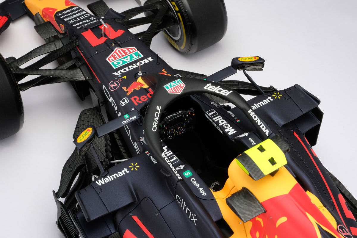 A detail close up of a 1:8 scale model of Sergio Perez's Red Bull Racing Honda RB16B on a neutral background.