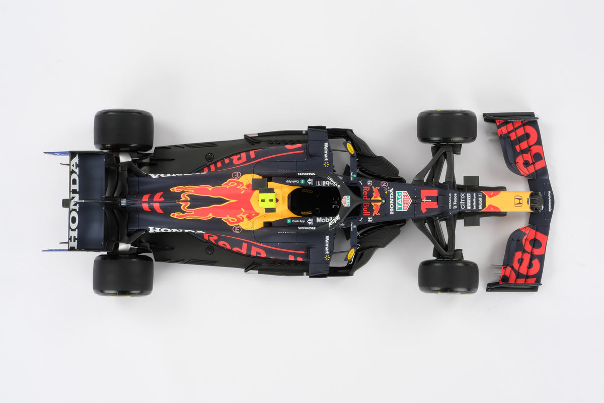 A top down shot of a 1:8 scale model of Sergio Perez's Red Bull Racing Honda RB16B on a neutral background.