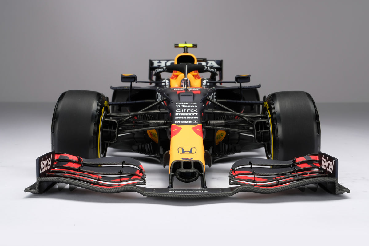 A 1:8 scale model of Sergio Perez's Red Bull Racing Honda RB16B on a neutral background.