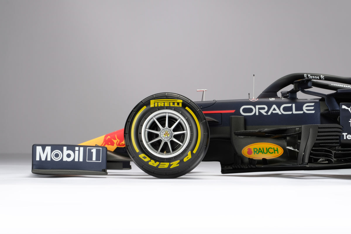 A detail close up of a 1:8 scale model of Sergio Perez's Red Bull Racing Honda RB16B on a neutral background.