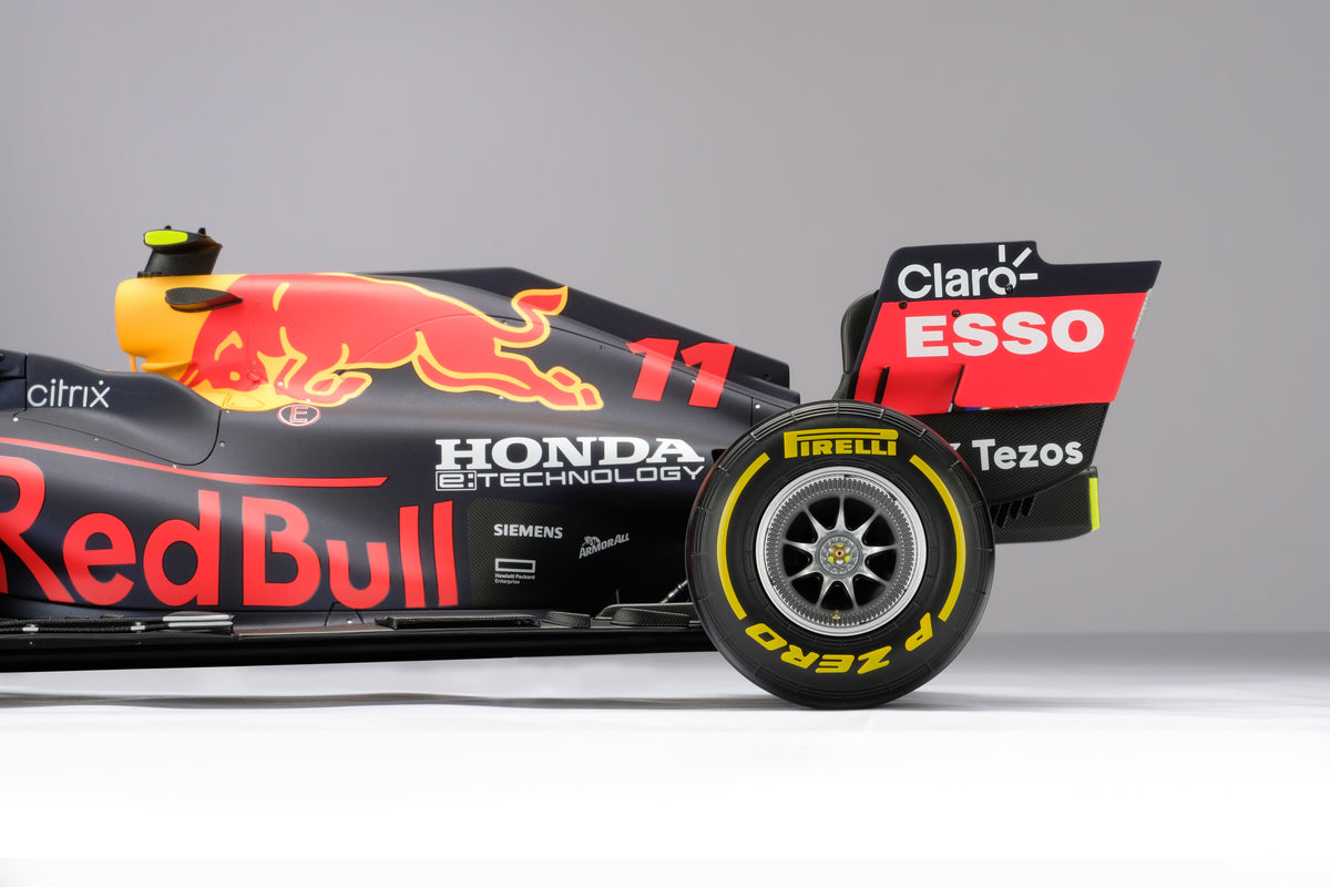 A detail close up of a 1:8 scale model of Sergio Perez's Red Bull Racing Honda RB16B on a neutral background.